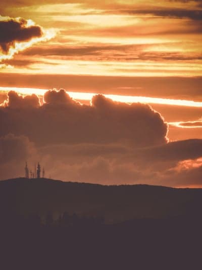 Fiery Evening Sky Over Radio Tower Hilltop Background
