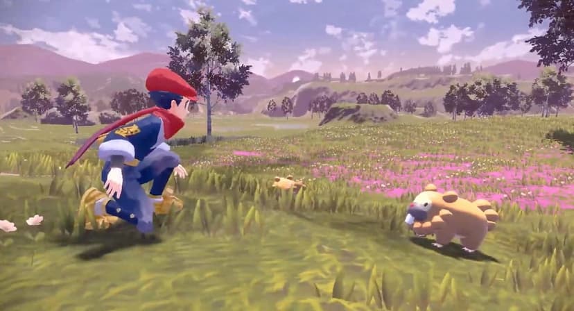A trainer in Hisuian gear crouches in a flowery field near a Bidoof under a pale sky in a vast gaming landscape.