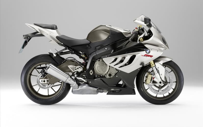 Silver and black BMW S1000RR sportbike with bronze wheels shown from the side against a gray background.