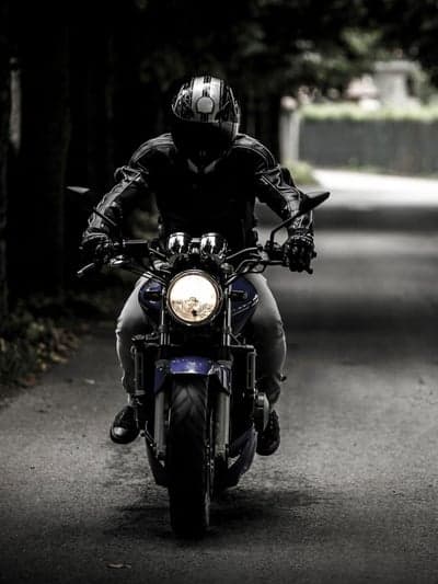 Rider on Motorcycle on Dark Road at Dusk