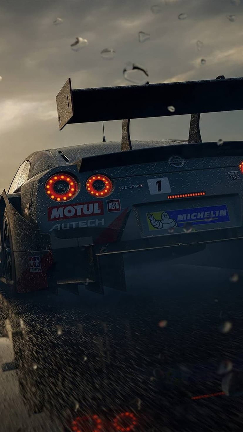 Nissan GT-R race car speeds on a wet track with glowing red taillights and water spray in a heavy rain storm.