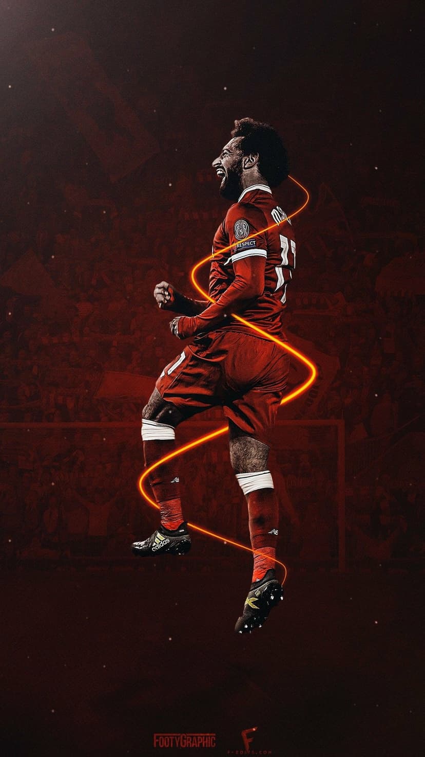 Mohamed Salah jumps in mid-air wearing a red jersey with number eleven surrounded by orange light trails.