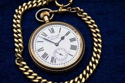 Antique Gold Pocket Watch with Chain on Blue Velvet