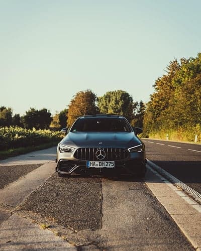 Dark Mercedes CLA AMG on a Sunny Road