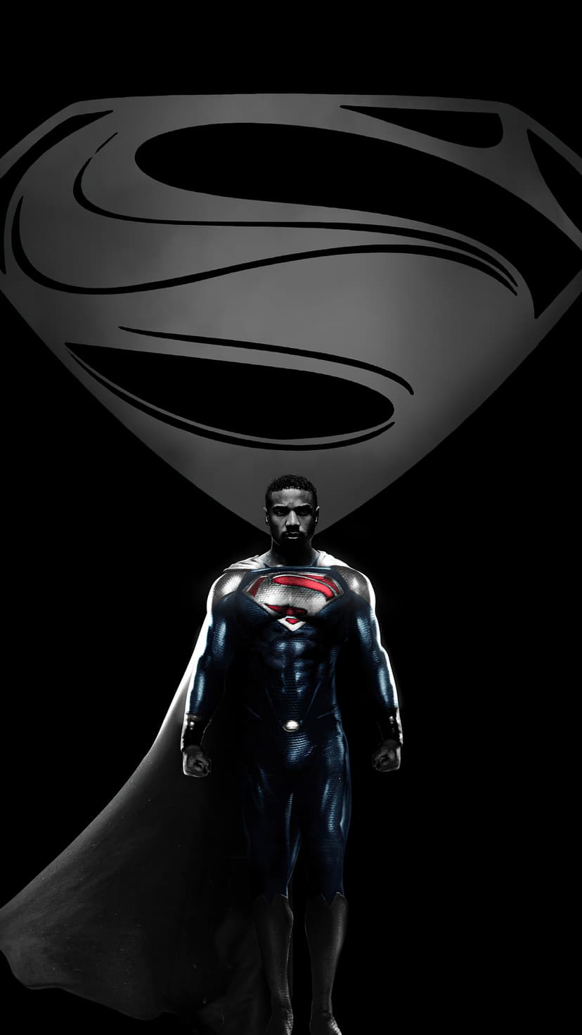 Michael B. Jordan as Superman wears a black textured suit with a red and yellow crest against a dark void.