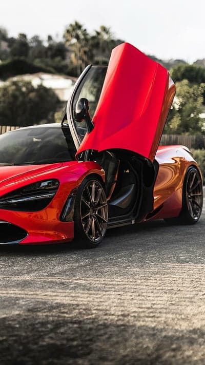 Red McLaren supercar with butterfly doors open