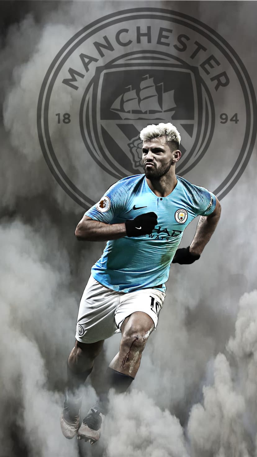 Sergio Aguero runs in a light blue jersey through white smoke against a large grey Manchester City club crest.