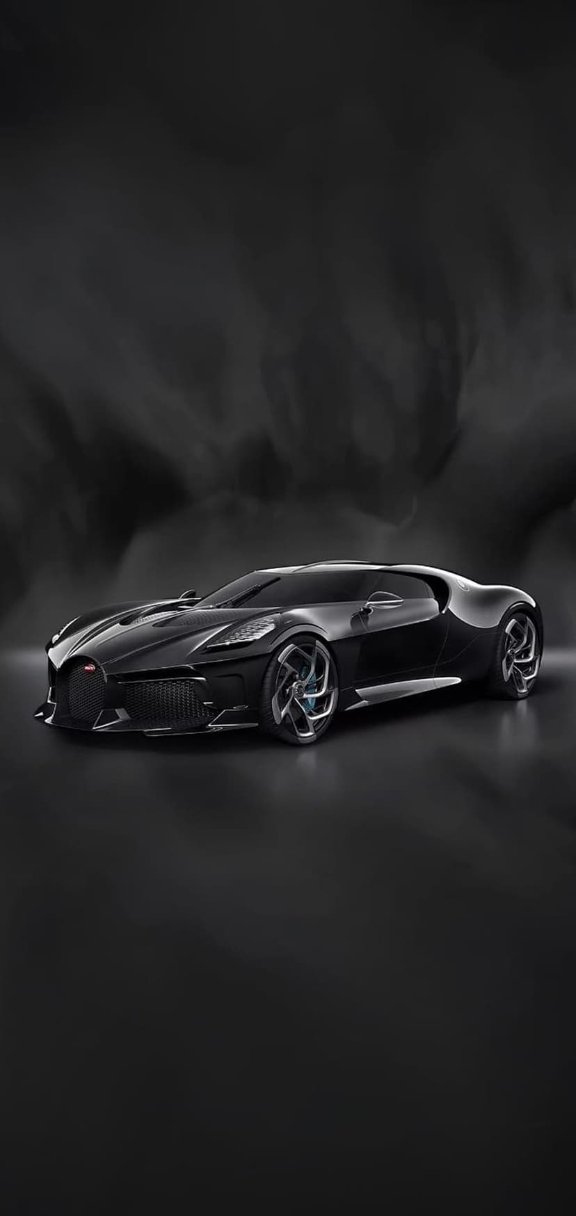 Black Bugatti hypercar with blue rim accents and aggressive headlights posed in a dark, atmospheric setting.