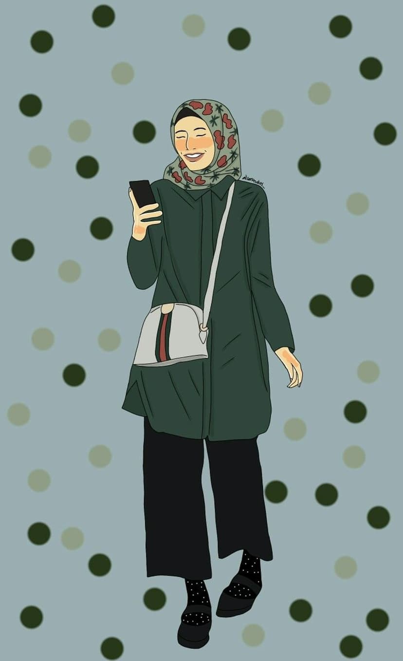 Woman in a floral hijab and green tunic smiles at her phone while wearing polka dot socks and Mary Jane shoes.
