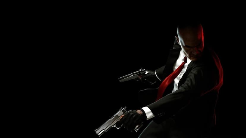 Agent 47 in a black suit and red tie dual-wielding silver pistols against a pitch black background with side lighting.