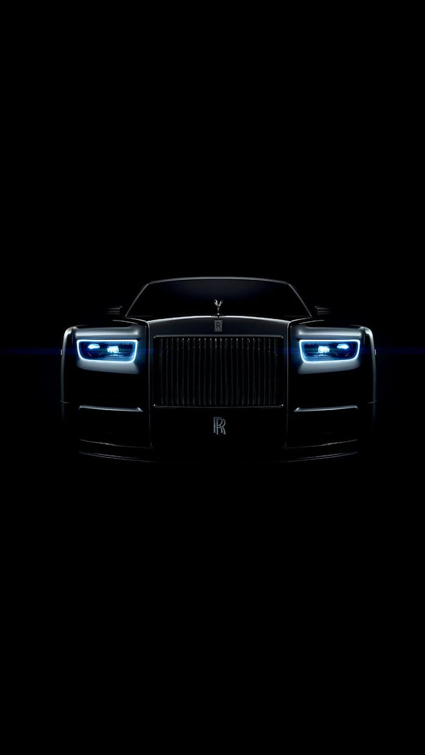 Rolls-Royce Phantom front grille and glowing blue LED headlights centered on a dark black background for mobile.