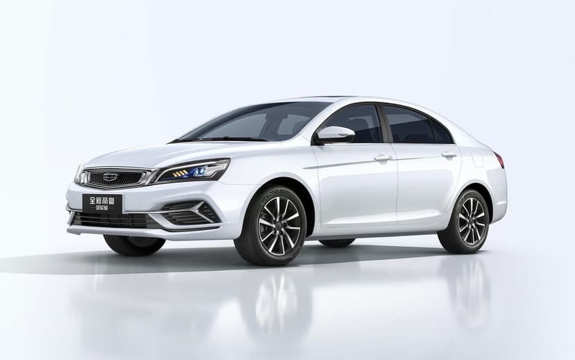 White sedan in a bright studio with soft floor reflections, multi-spoke wheels, and sharp LED headlights.