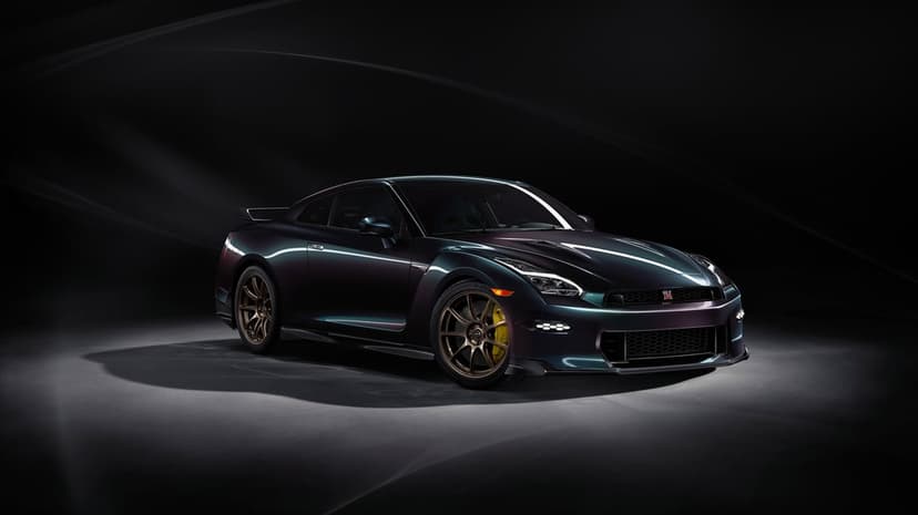 Nissan GT-R T-Spec Takumi Edition profile view featuring metallic paint and bronze wheels in a studio setting.