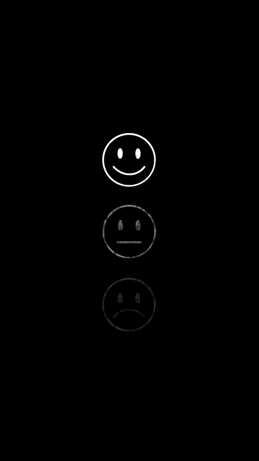 Happy, neutral, and sad line-art emoticons stacked vertically with a reflective effect on a pitch-black surface.