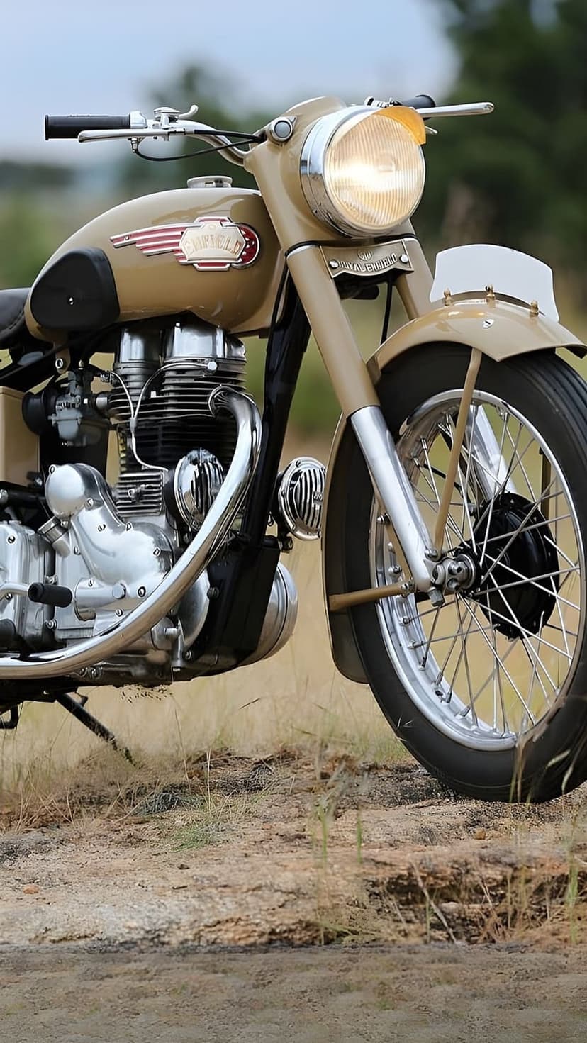 Vintage Royal Enfield motorcycle in sandy beige with chrome exhaust parked on dry, grassy desert terrain.