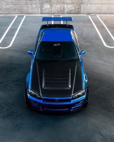 Blue Nissan Skyline R34 GT-R with Carbon Hood