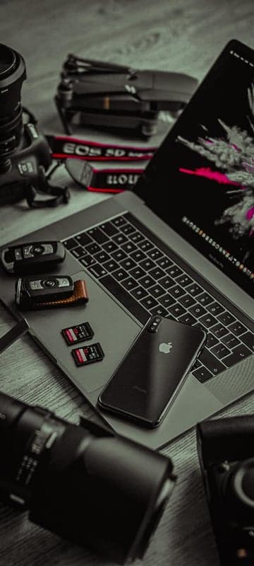Tech photographer's gear: Laptop, phone, camera, drone, keys