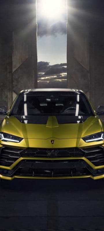 Yellow Lamborghini Urus emerges from dramatic doorway