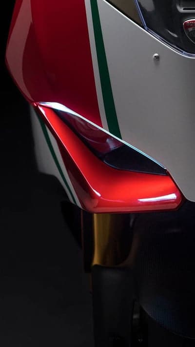 Close-up of red, white, and green motorcycle fairing detail