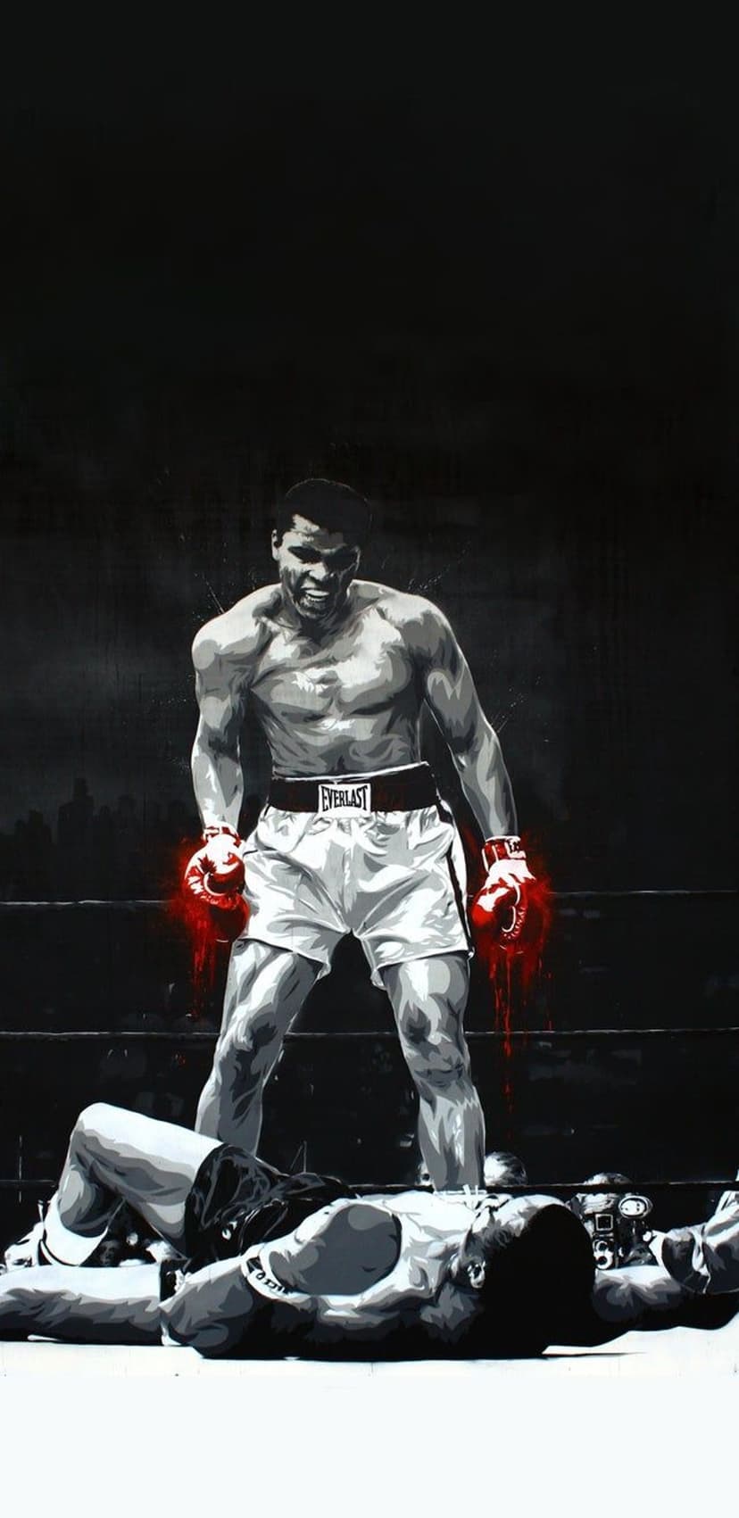 Boxer wearing red gloves stands over a defeated man on a ring mat against a dark urban city background.