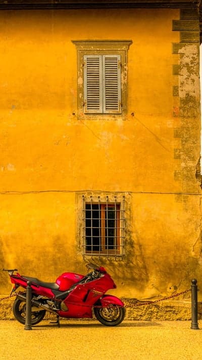 Red Sportbike and Rustic Yellow Stucco Wall Wallpaper