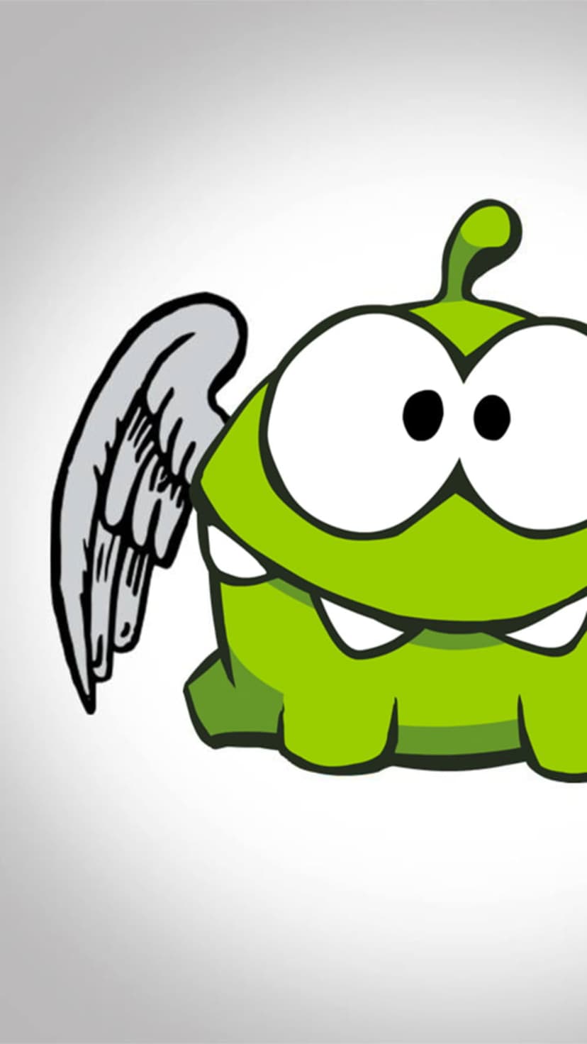 Green Om Nom monster with a gray angel wing and wide toothy grin stands against a white gradient background.