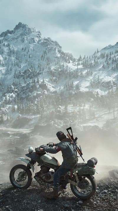 Man on motorcycle with rifle in snowy mountains
