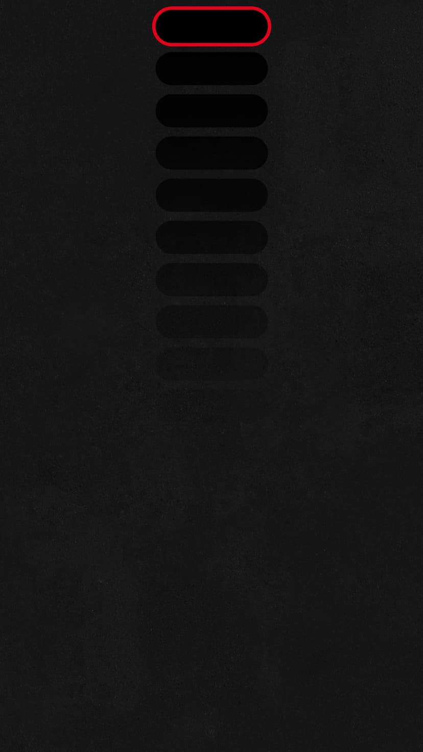 Red glowing oval outline highlights the top button of a vertical stack against a dark, textured black background.