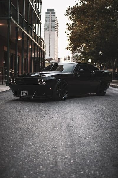 Sleek Black Dodge Challenger Muscle Car Mobile Wallpaper