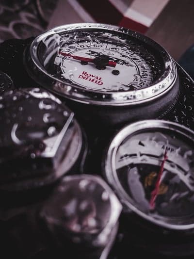 Royal Enfield motorcycle gauges with water droplets