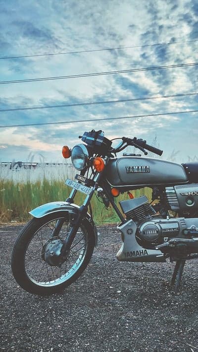 Vintage Yamaha RX100 Bike Rural Sunset Mobile Background