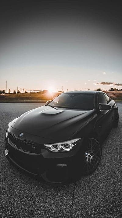 Black BMW M4 G82 Sunset Silhouette Phone Background