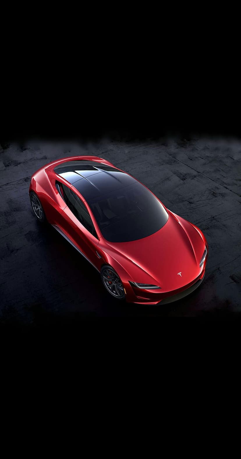 Red Tesla Roadster featuring a panoramic black roof and LED headlights on a dark, grainy textured surface.