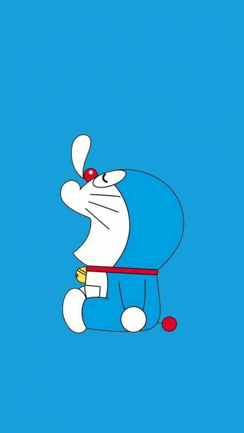 Doraemon gazes upward with wide eyes and a red nose against a solid blue background with a yellow bell visible.