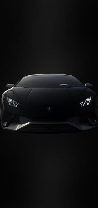 Sleek Black Lamborghini Sports Car Headlights On