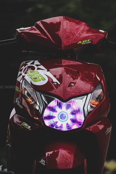 Custom red scooter with custom headlight and racing decals