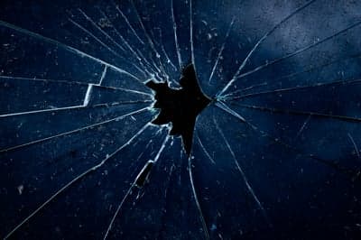 Dark Shattered Glass Texture with Radial Cracks