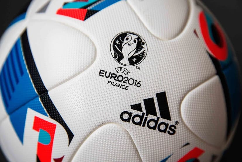 Beau Jeu soccer ball macro features blue and red synthetic panels with the UEFA Euro 2016 tournament logo.