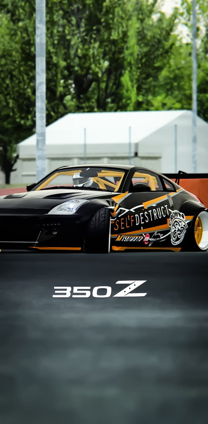 Nissan 350Z sports car in black with orange racing decals and a visible roll cage on an asphalt surface.