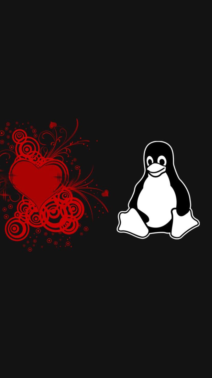 Tux the Linux penguin stands beside a red filigree heart on a solid black background for mobile screens.