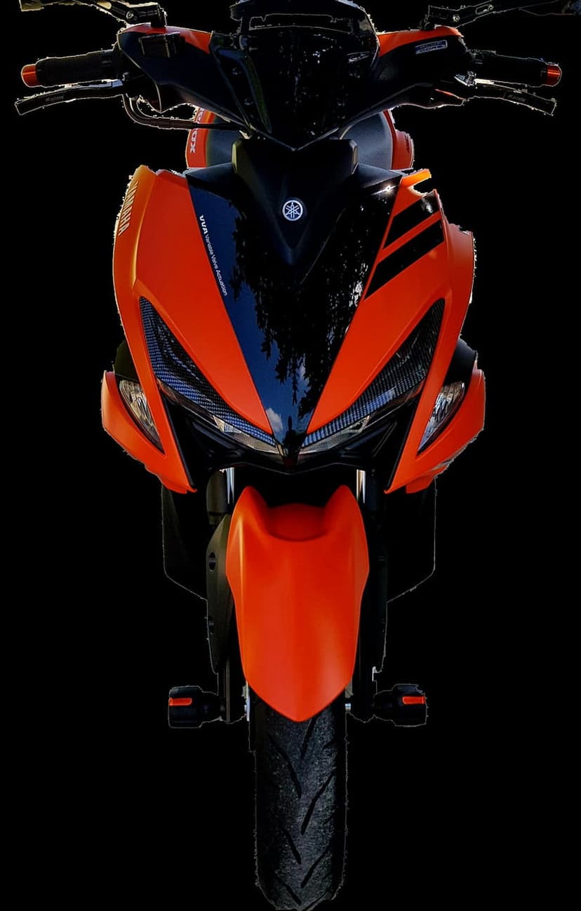 Orange Yamaha scooter with black accents showcases twin headlights and a prominent logo on its front bodywork.
