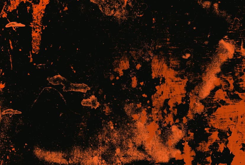 Vibrant orange paint splatters and weathered streaks cover a dark black distressed surface with a raw texture.