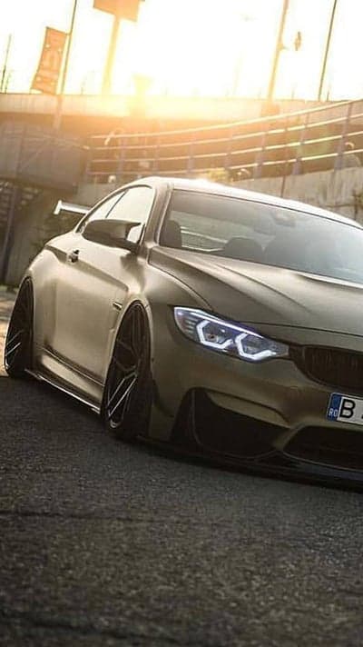Aggressive BMW M4 sports car in golden matte finish