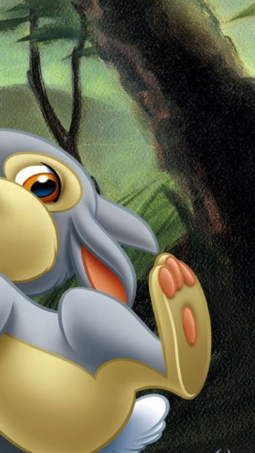 Thumper the bunny raises a pink-padded paw amidst dark tree trunks and vibrant green forest foliage in close-up.