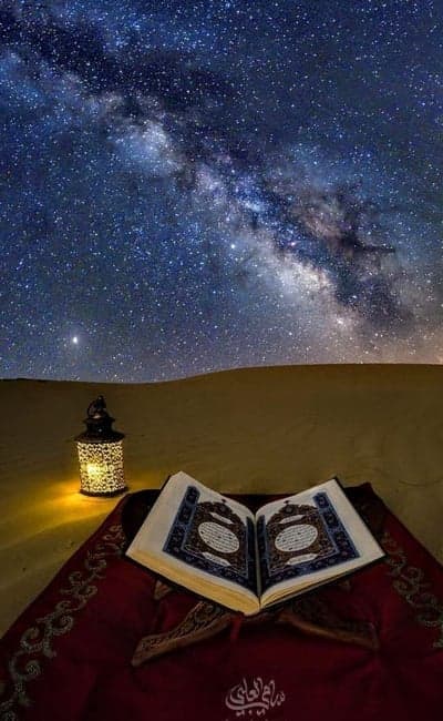 Quran Under Milky Way in Desert with Lantern