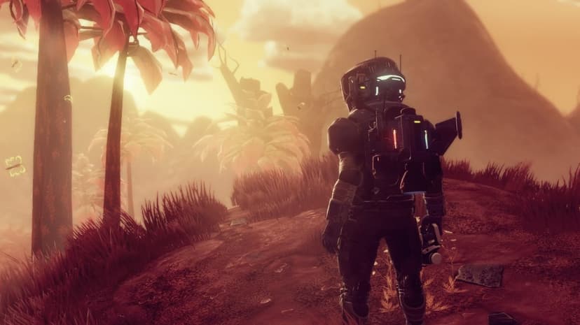 Astronaut in a dark suit stands on a red grass hill looking at a hazy alien forest under a golden sky.