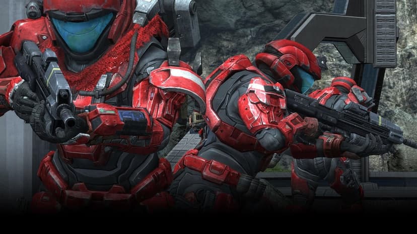 Three Spartans in red battle armor holding rifles in a rocky canyon with blue glowing visors.