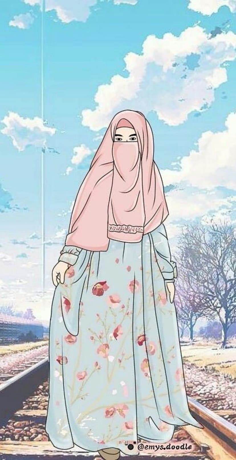 Young woman in a pink niqab and floral blue dress stands by railway tracks under a cloudy sky with bare trees.