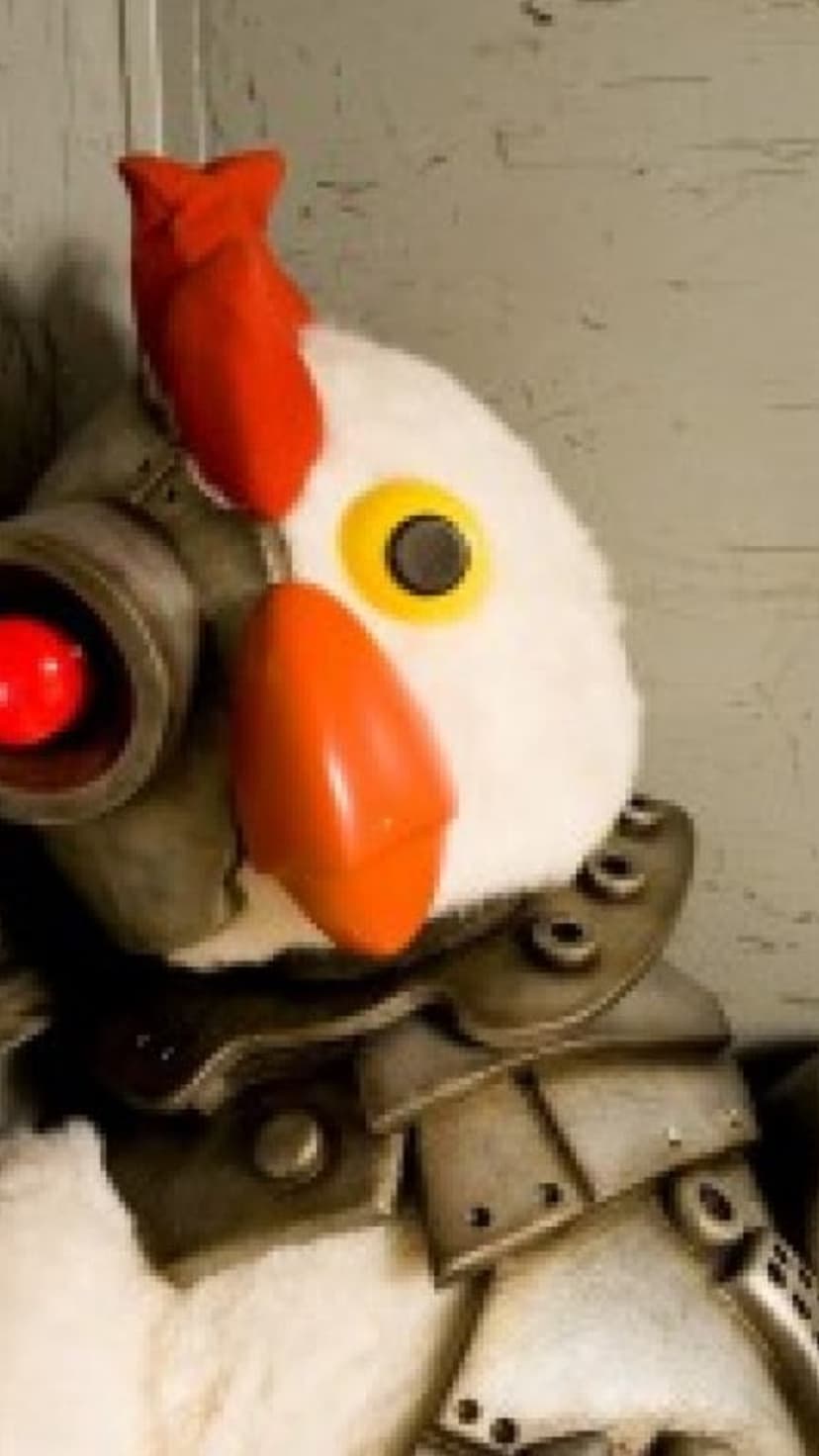 Robotic chicken with a glowing red eye lens and metallic armor plating covering its white feathered body.