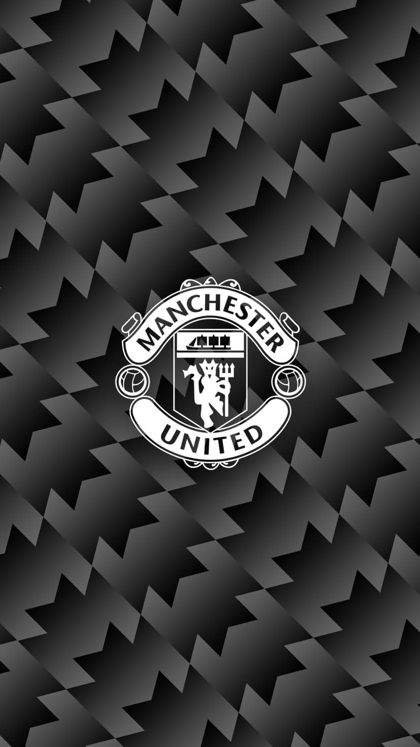 Manchester United football crest centered on a black and grey patterned background with sharp geometric shapes.